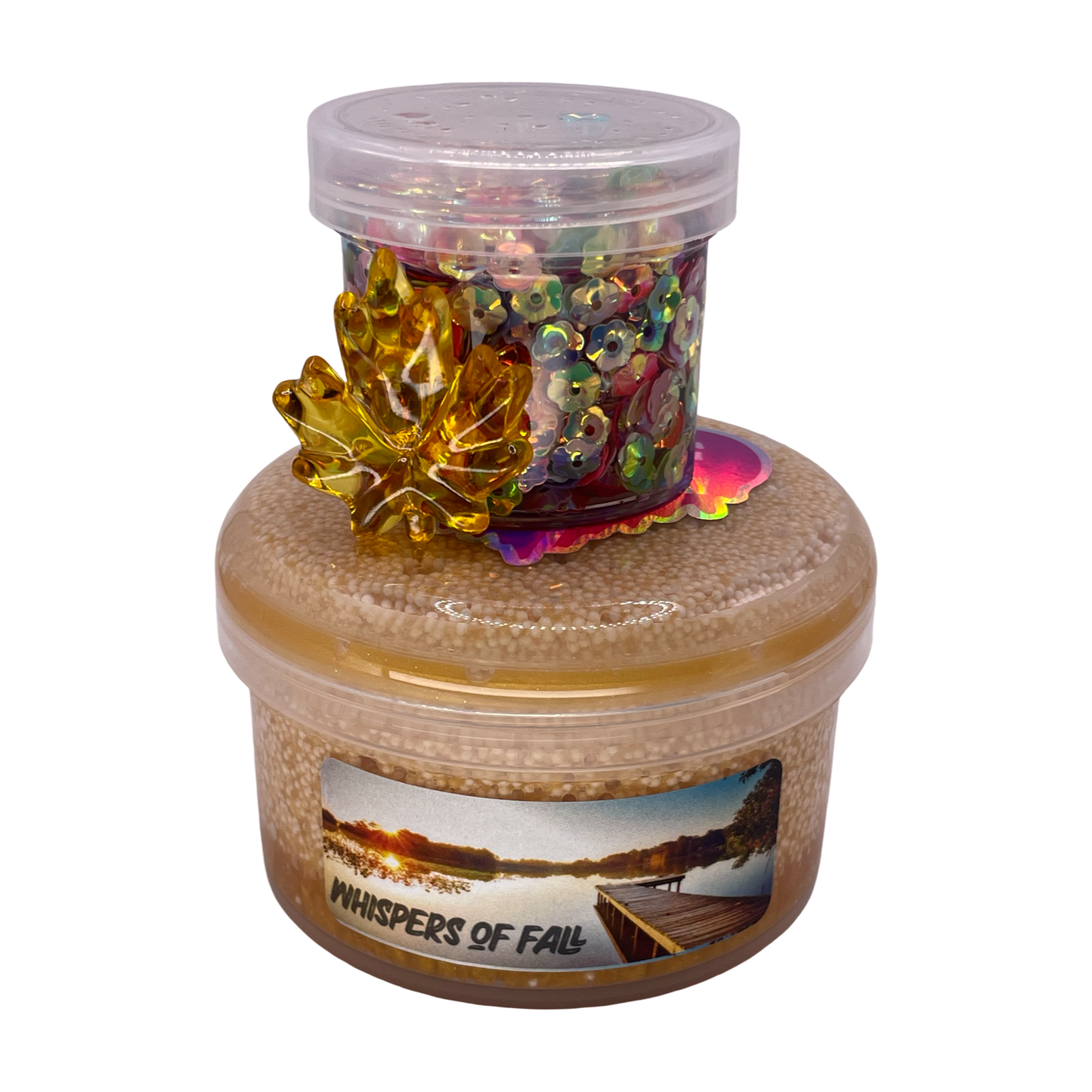 Decorative container with a gold leaf, colorful beads, and 'Whispers of Fall' label on a white background