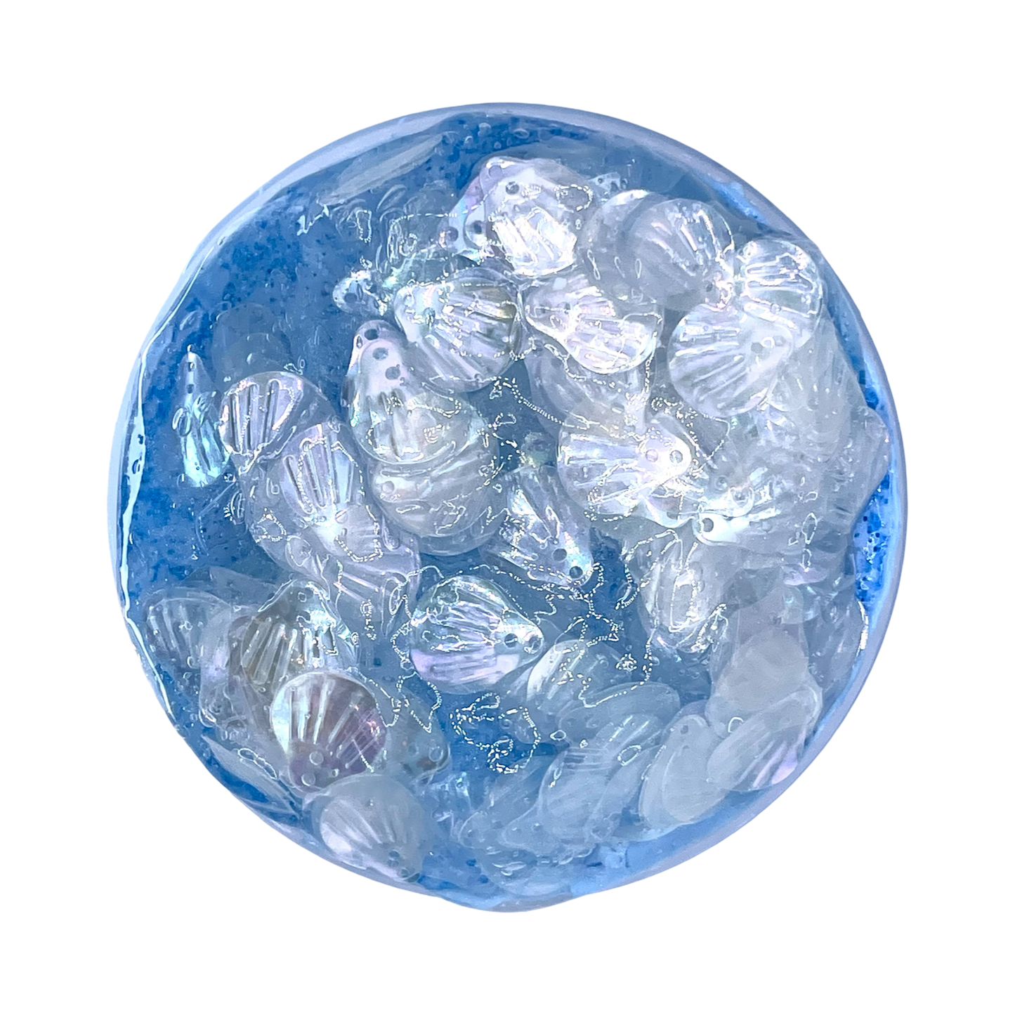 Clear plastic seashells inside a blue glass sphere on a white background