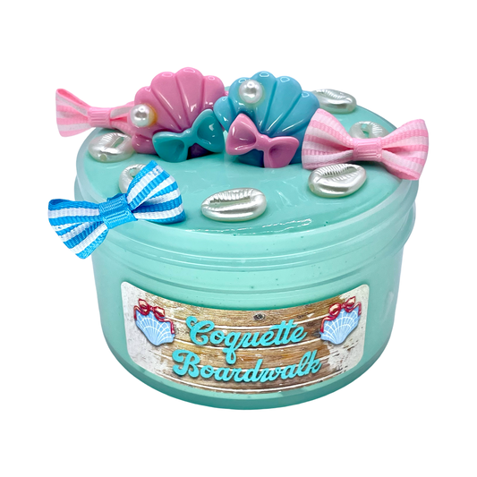 Decorative item with bows, seashells, and a label on a white background